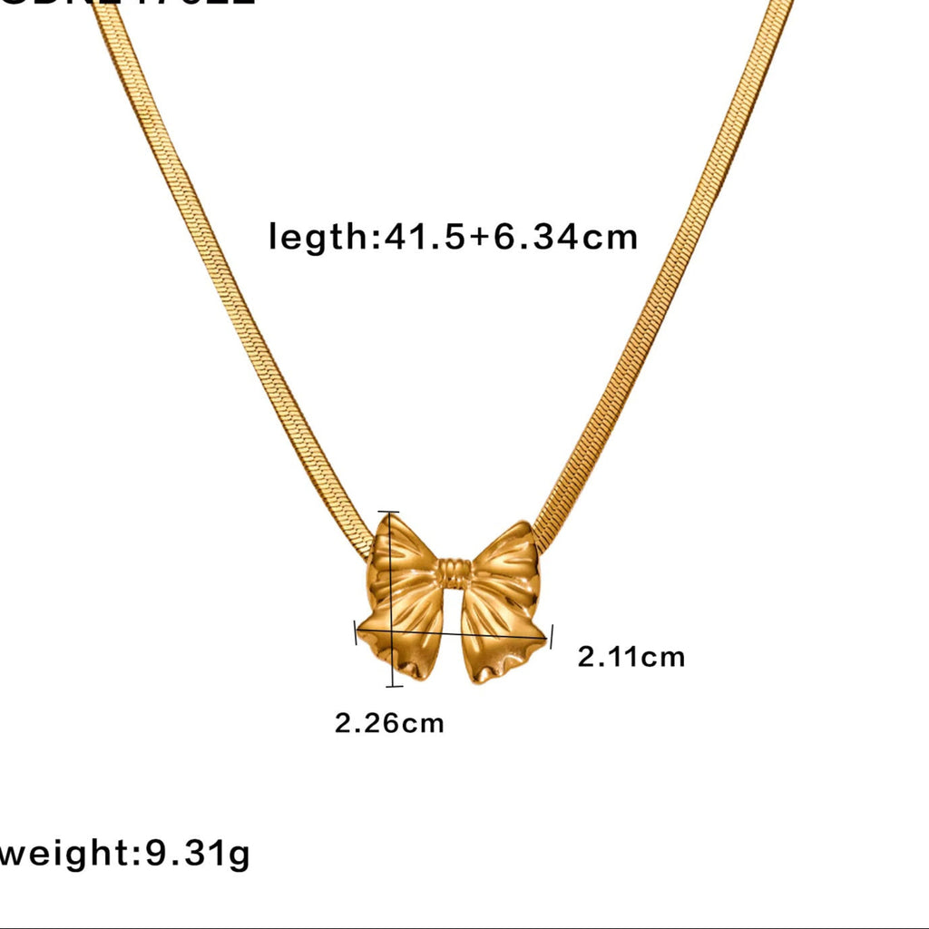 Gold necklace with a bow pendant, showing measurements 