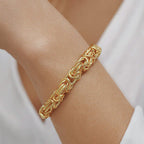 Close-up of a woman's wrist wearing a 18K gold  chain bracelet 