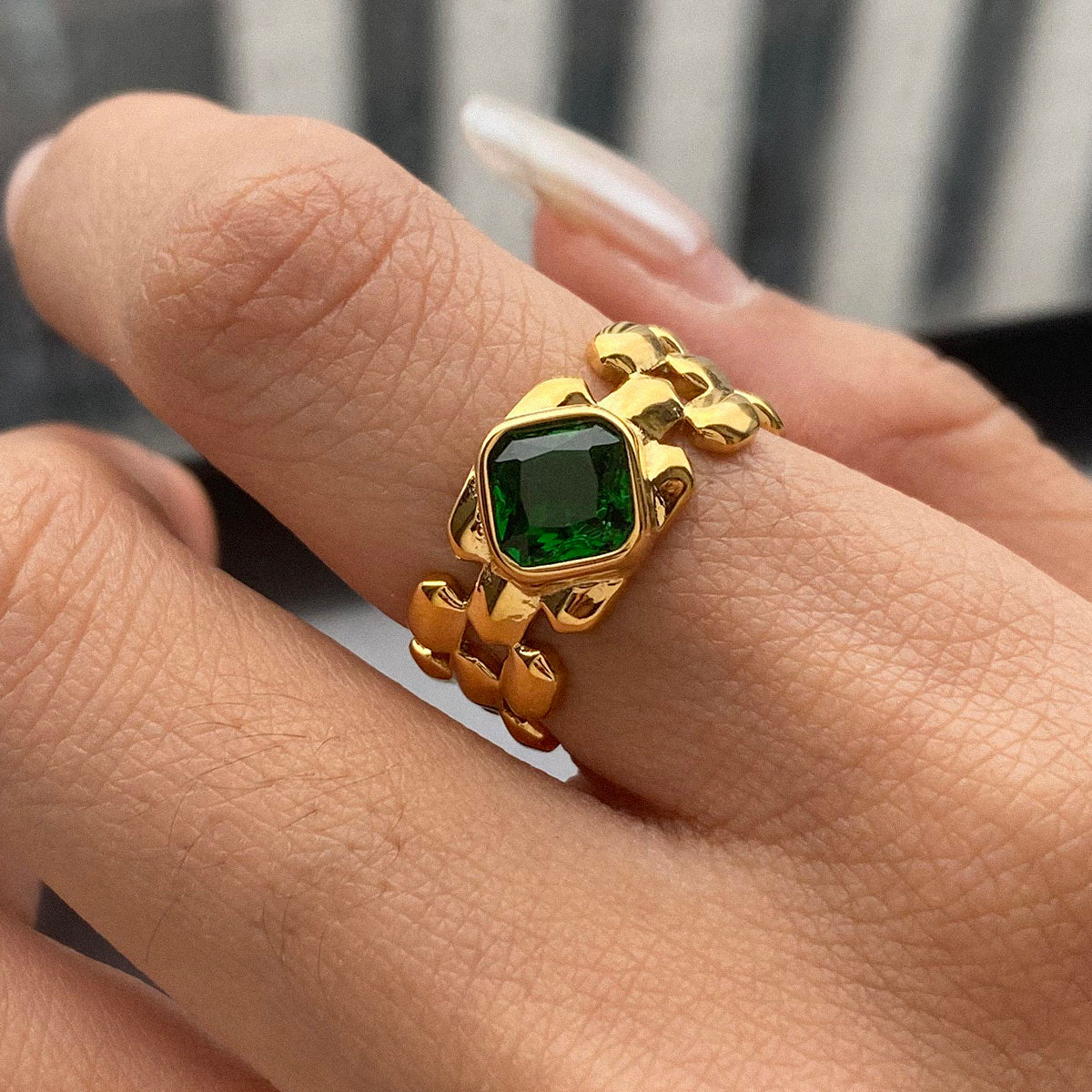 Gold ring with a green gemstone 