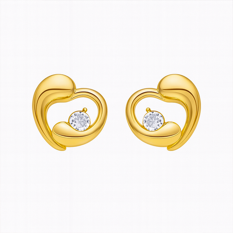 Gold heart-shaped earrings with embedded diamonds on a white background