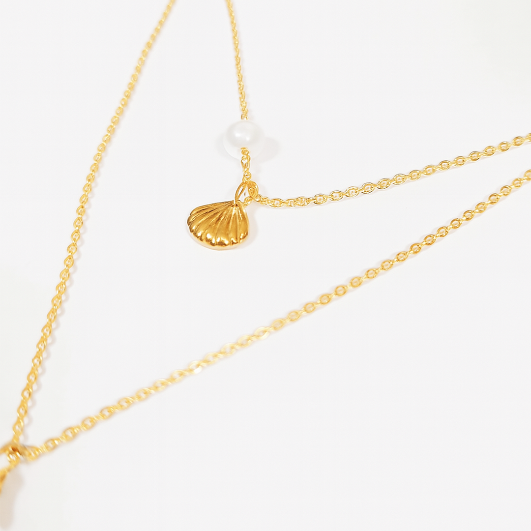 Gold necklace with a shell pendant