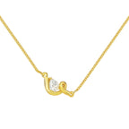 A delicate gold chain necklace featuring a teardrop-shaped diamond pendant with a unique twisted design.